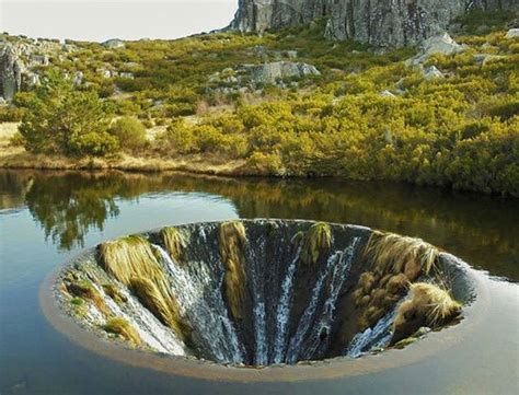 Heres A Lake In Portugal That Funnels Into A Huge Drain Like Waterfall