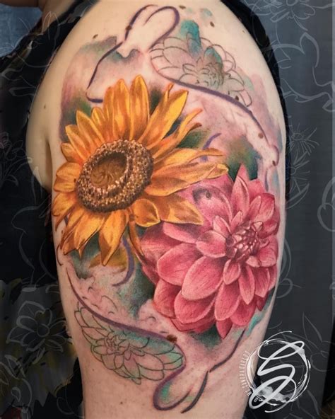 The carnation flower tattoo is well suited for people who have deep faith in christianity. Sunflower and a baby Dahlia. 🐇🌻 . Thank you Lucy!!! 🖤 . . . #sunflowertattoo #dahlias # ...
