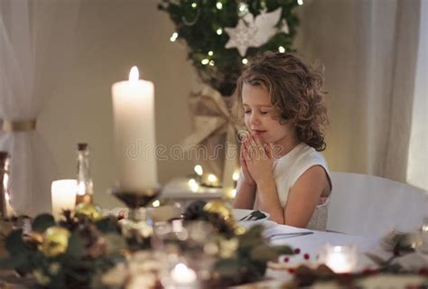 Girl With Clasped Hands And Eyes Closed Praying Stock