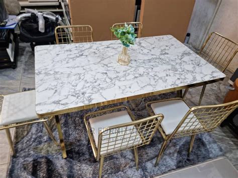 gold net design dinning chair and black and white table in kaneshie furniture r furniture