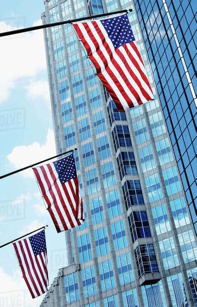 American Flags Against Office Buildings Stock Photo Dissolve