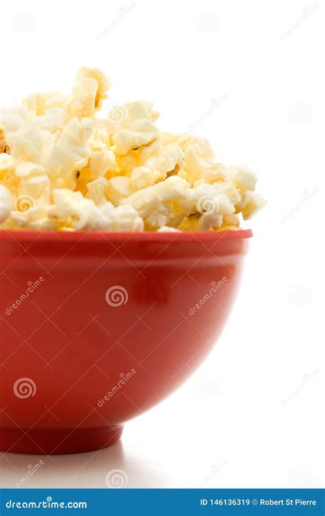 Close Side View Of Buttered Popcorn In A Red Bowl Isolated On White