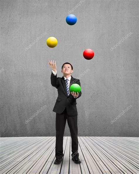 Man Throwing And Catching Colorful Balls — Stock Photo © Bruesw 74282275