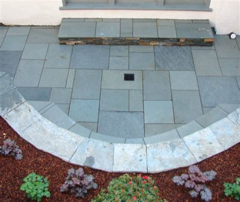 Do it yourself, install a patio drain. Yard Drainage in Landscape Design