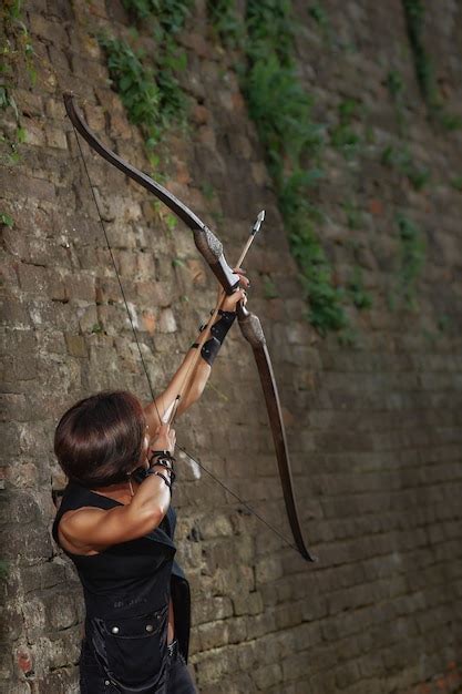 Female Warrior Shooting From Bow At Sky Premium Photo