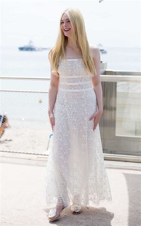 Elle Fanning In A White Dress Leaves Hotel Martinez During The 76th