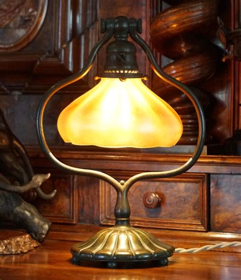 Finial is used to tighten and keep in place the lamp shade for any type of lamp that has a lamp harp or clip adaptor. Tiffany Studios Bronze and Favrile Harp Table Desk Lamp For Sale at 1stdibs