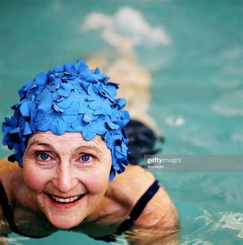 Elderly Woman Smiling Wearing A Swimming Cap In A Swimming Pool Photo