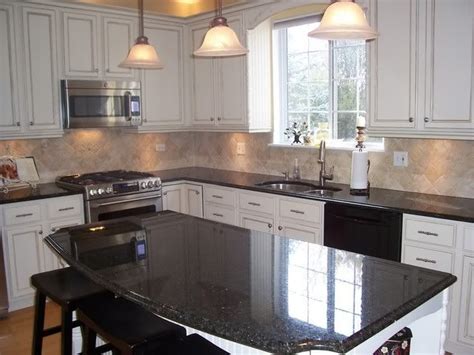 It's a proven durable surface with many unique benefits. Kitchen. Black granite countertops. Oak cabinets painted ...