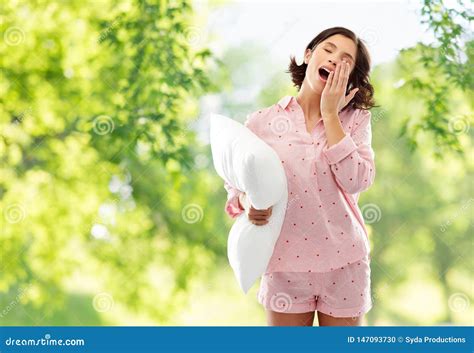Sleepy Yawning Young Woman In Pajama With Pillow Stock Photo Image Of