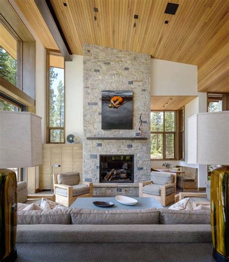 A Living Room Filled With Furniture And A Fire Place In The Middle Of A