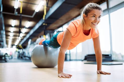 Young Attractive Woman Doing Push Ups Using Ball Myfitness