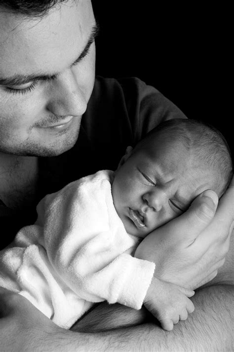 Grayscale Photo of Man Holding Baby · Free Stock Photo