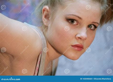 Portrait Of A Natural Blonde Teen Girl Leaned Forward Stock Photo