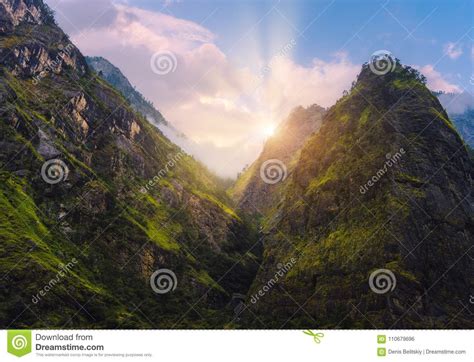 Mountains Peaks Covered Green Grass And Trees At Sunset Stock Photo