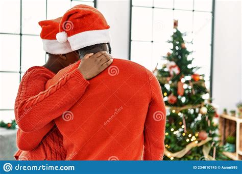 Young African American Couple On Back View Hugging And Standing By