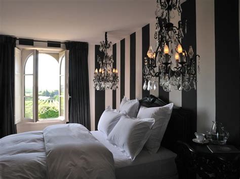 This elegantly serious black master's bedroom adorned with crystal chandelier and bejewelled wall accent and mirrors create a masculine and modish design scheme. 10 Amazing Black and White Bedrooms - Decoholic