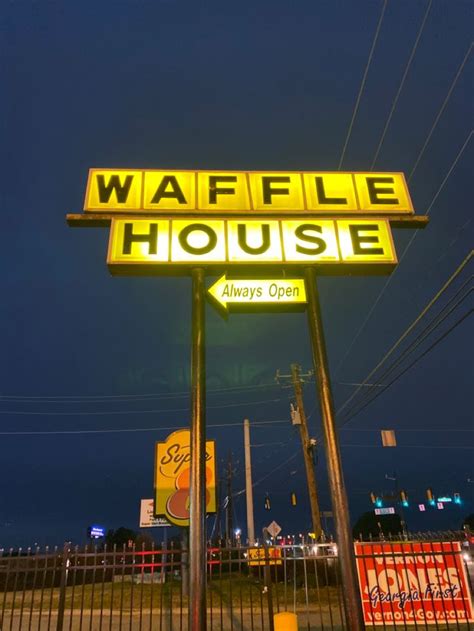 The Sign For Waffle House Is Lit Up At Night