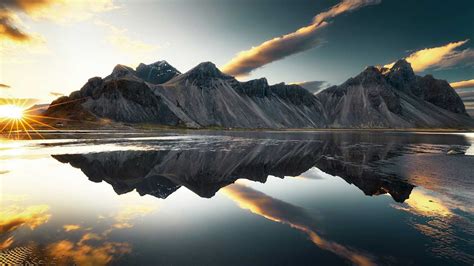 1600x900 Mountains Clouds Lake Reflection Sun Sky 1600x900 Resolution