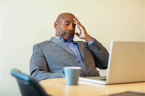 African American Man Having A Difficult Time At Work Stock Image