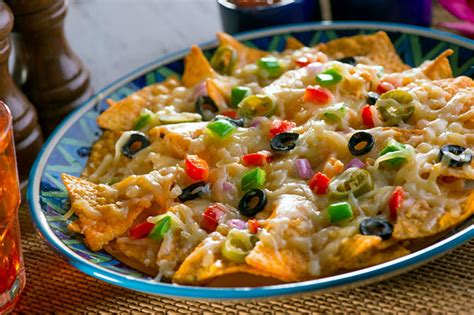 In a small bowl, whisk together the olive oil, oregano, garlic powder and crushed red pepper. How to make Nachos Pizza at home - Rediff.com Get Ahead