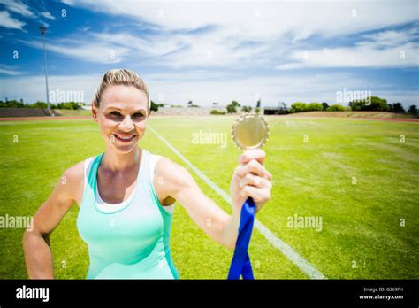 Portrait Of Female Athlete Showing Her Gold Medal Stock Photo Alamy