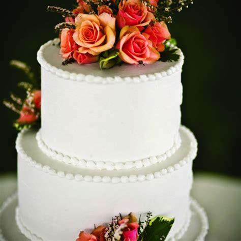Three Tiered Wedding Cake With Fresh Flowers On Top