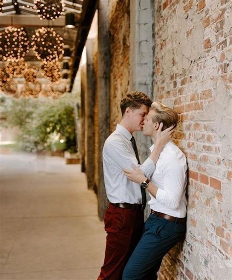 Young Love Cute Gay Couple Kissing Against A Brick Wall