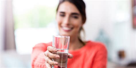 Young Woman Showing Drinking Glass With Water Ask The Scientists