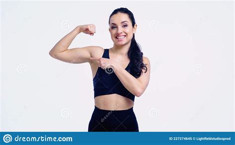 Smiling Sportswoman Pointing At Muscle Stock Image Image Of Happy Sportswear