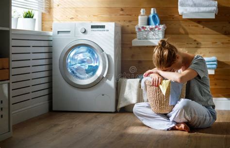Tired Housewife Woman In Stress Sleeps In Laundry Room With Wash Stock