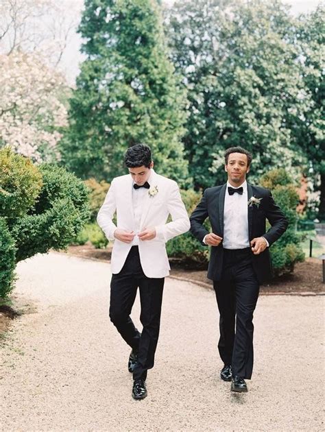 Two Men In Tuxedos Walking Down A Path