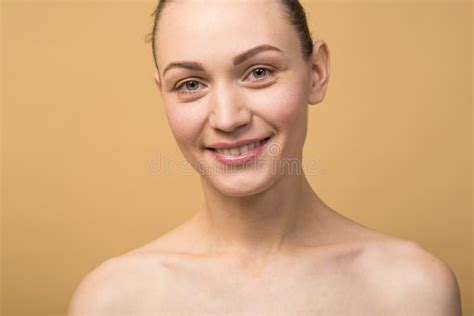 Portrait Of Attractive And Happy Naked Caucasian Girl Isolated On Beige