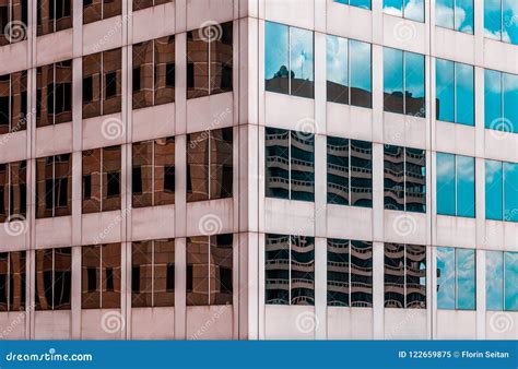 Close Up Of Skyscraper With Buildings Reflecting In The Windows Stock
