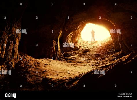 Man Exploring Dark Cave Stock Photo Alamy