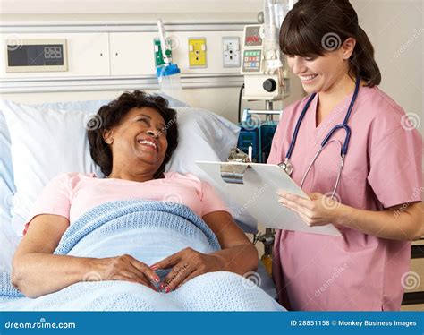 Nurse Visiting Senior Female Patient On Ward Stock Photo Image Of