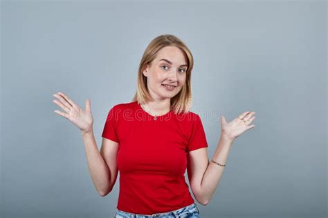 Attractive Caucasian Young Woman Spreading Hands And Looking So Funny