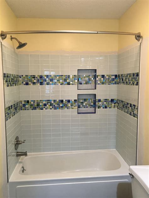 A Pair Of Parallel Seaside Glass Tile Stripes Gives This Modern Bathroom A Beachy Vibe