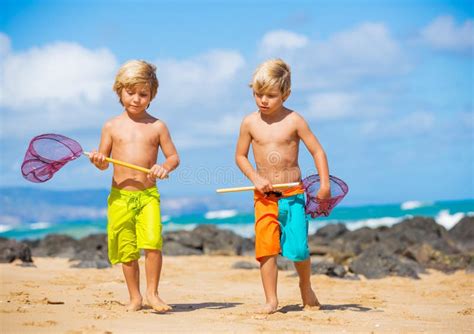 Happy Young Kids Playing At The Beach On Summer Vacation Stock Image