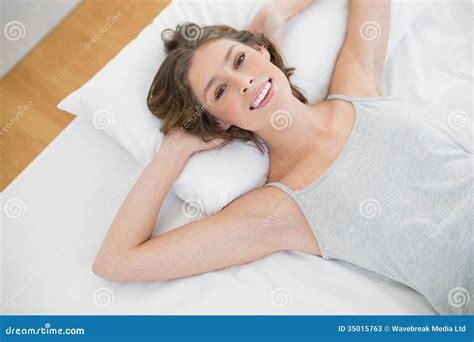 Content Calm Woman Lying On Her White Bed In The Bedroom Stock Image