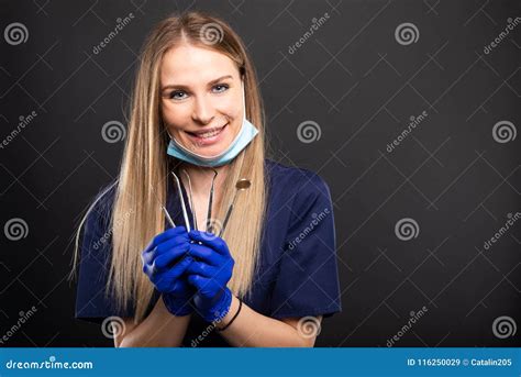 beautiful female dentist wearing scrubs showing tools stock image image of girl health 116250029