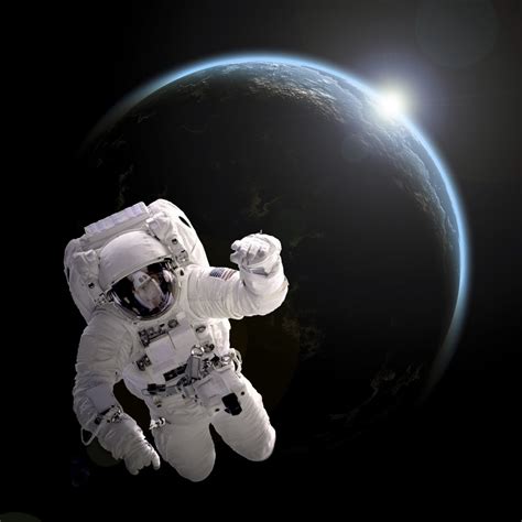 Astronaut Floating In Space As The Sun Rises On An Earth Like Planet