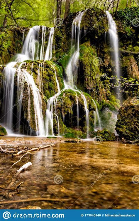 Long Exposure Of A Beautiful Waterfall With Green Moss Stock Photo