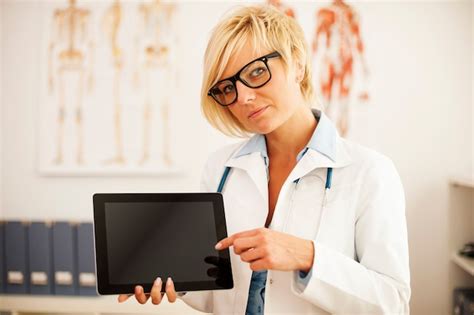 Free Photo Serious Female Doctor Pointing At Digital Tablet