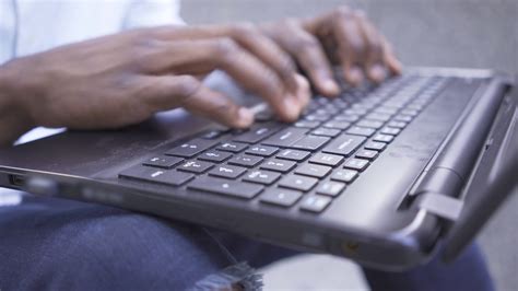 Close Up Hands Of African American Man Typing Fast On The Keyboard Of