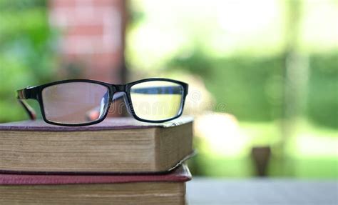 Stack Of Books With Reading Glasses On Top Green Nature Background Stock Image Image Of