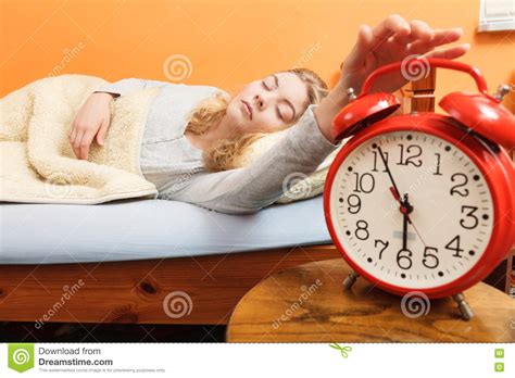 Woman Waking Up Turning Off Alarm Clock In Morning Stock Photo Image