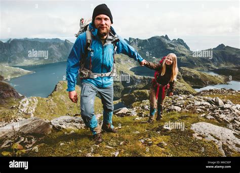 Happy Couple Hiking In Norway Mountains Love And Travel Holding Hands