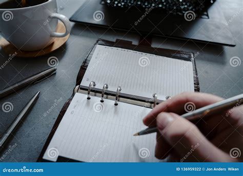 Hand Writing In Notebook With Laptop As Background Stock Photo Image