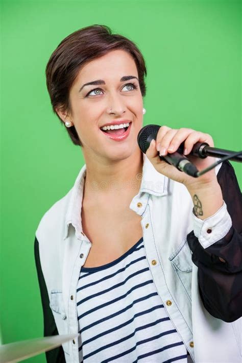 Young Woman Singing While Holding Microphone Stock Photo Image Of
